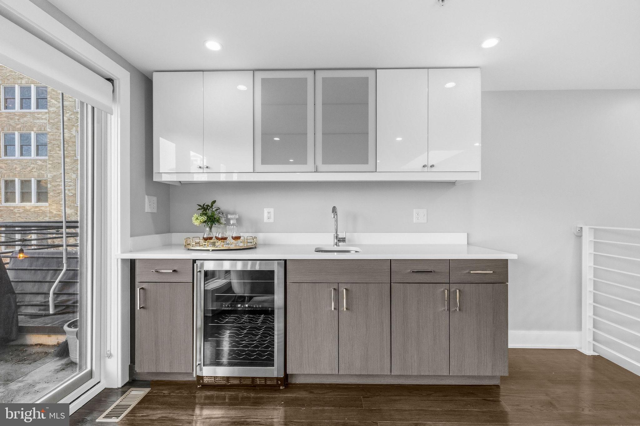 2012 Kalorama Road Northwest, Unit 8 Washington, DC 20009 - Photo 20 of 25 a kitchen with stainless steel appliances granite countertop a sink and cabinets with wooden floor