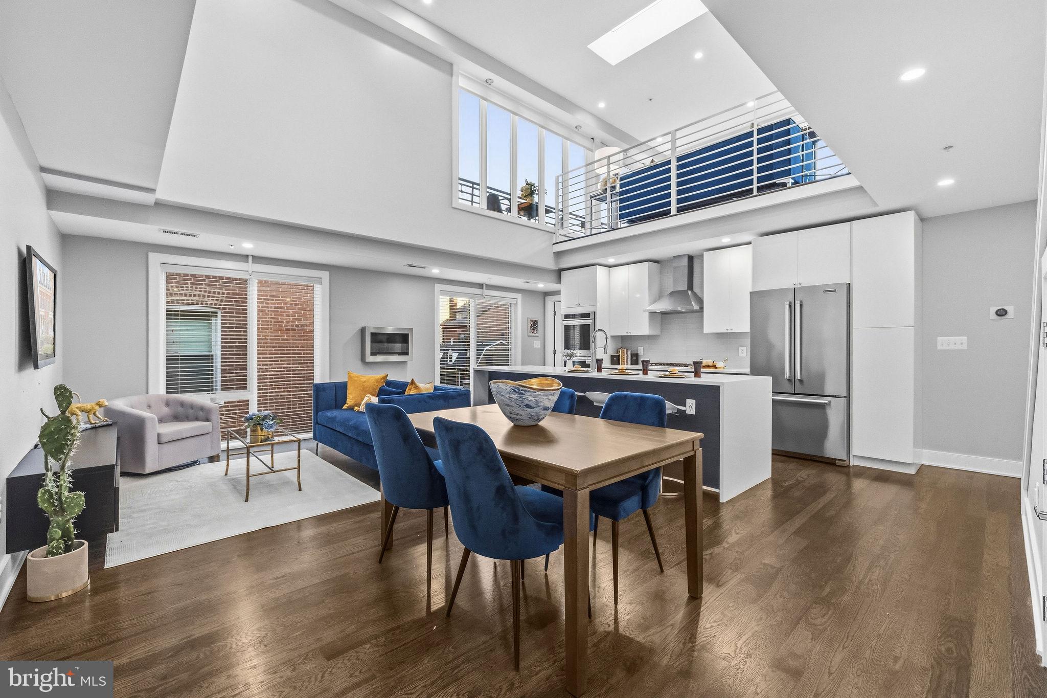 2012 Kalorama Road Northwest, Unit 8 Washington, DC 20009 - Photo 2 of 25 a dining room with stainless steel appliances kitchen island granite countertop furniture wooden floor and a kitchen view
