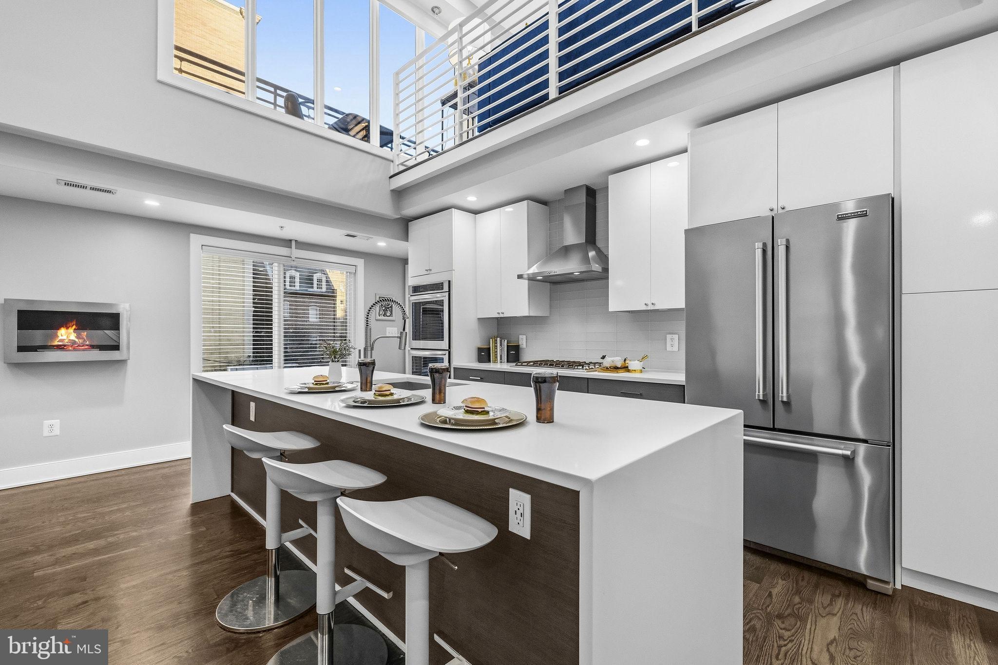 2012 Kalorama Road Northwest, Unit 8 Washington, DC 20009 - Photo 4 of 25 a kitchen with stainless steel appliances granite countertop a sink and a refrigerator