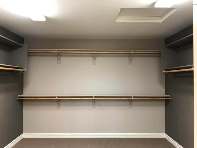 a view of staircase with lots of frames on wall and wooden floor