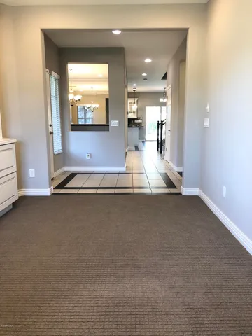 a view of a hall way with furniture