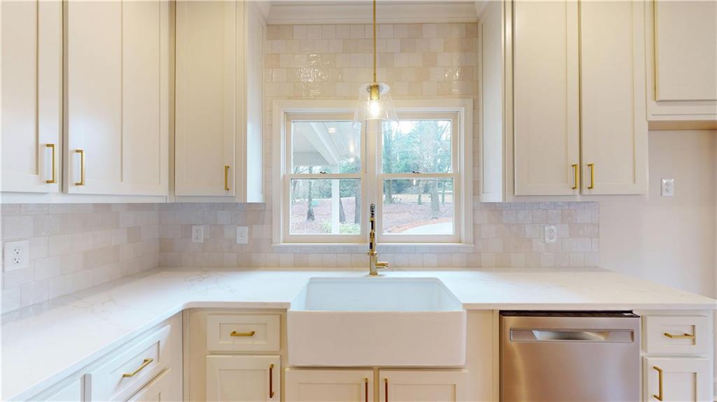 66 Highland Drive Jefferson, GA 30549 - Photo 12 of 63 a kitchen with granite countertop a sink and a white cabinets