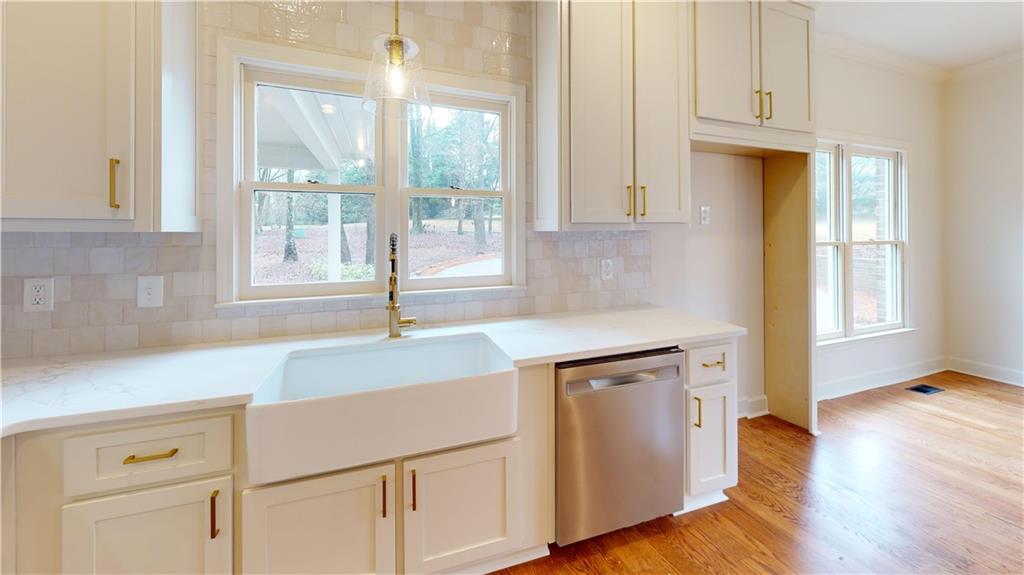 66 Highland Drive Jefferson, GA 30549 - Photo 13 of 63 a kitchen with granite countertop white cabinets and a wooden floor