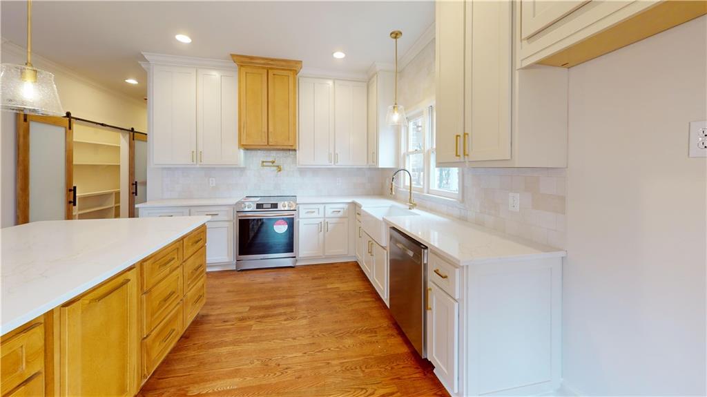 66 Highland Drive Jefferson, GA 30549 - Photo 14 of 63 a large kitchen with stainless steel appliances granite countertop a stove a sink and a refrigerator