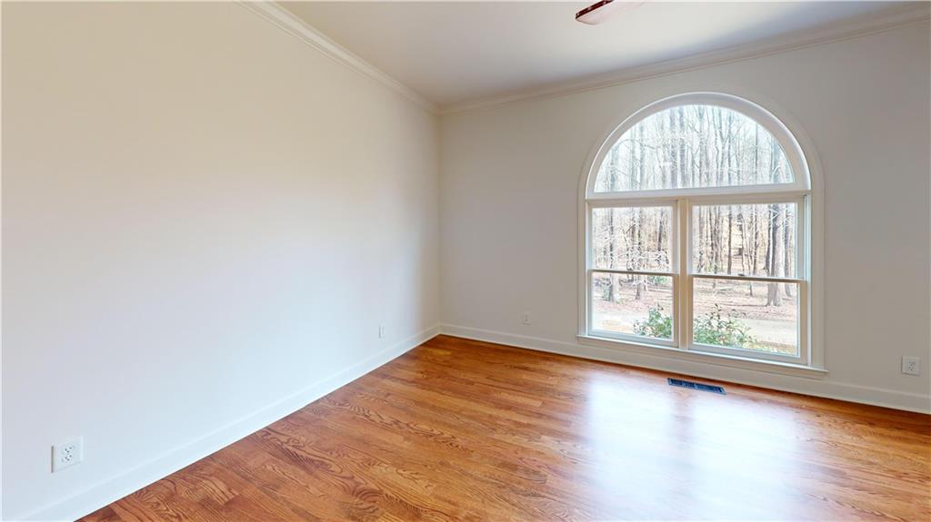 66 Highland Drive Jefferson, GA 30549 - Photo 39 of 63 an empty room with wooden floor windows and entrance