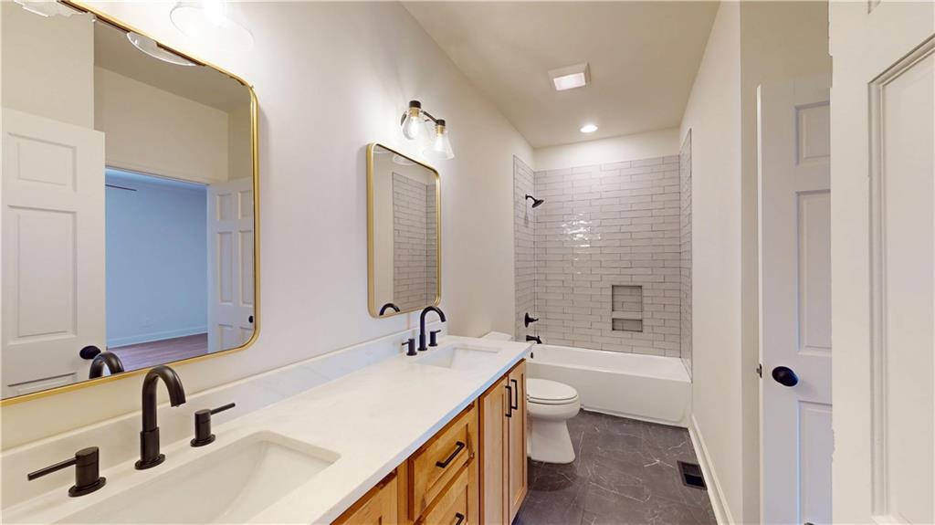 66 Highland Drive Jefferson, GA 30549 - Photo 42 of 63 a bathroom with a double vanity sink a toilet and shower