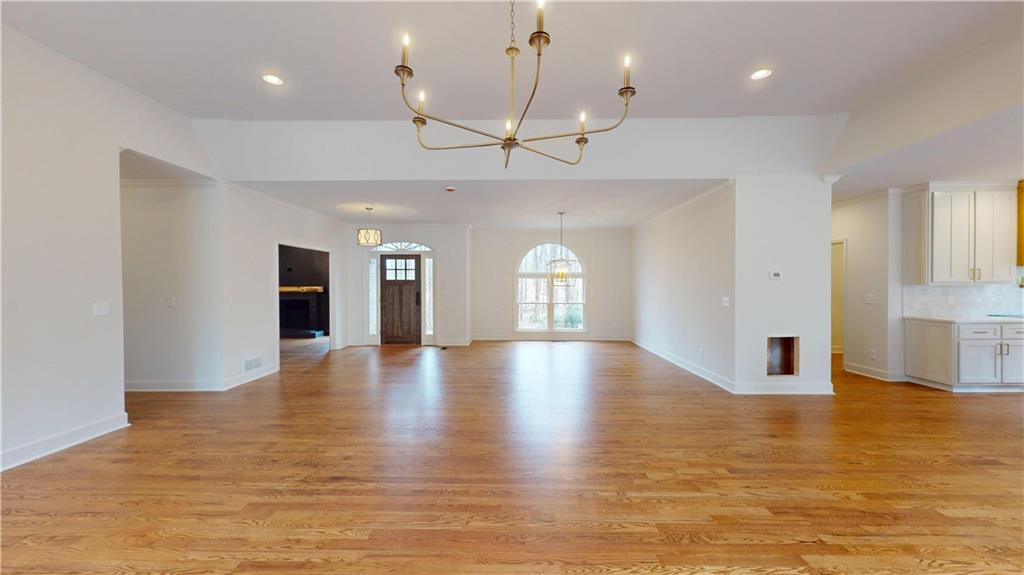 66 Highland Drive Jefferson, GA 30549 - Photo 48 of 63 a view of empty room with wooden floor and kitchen view