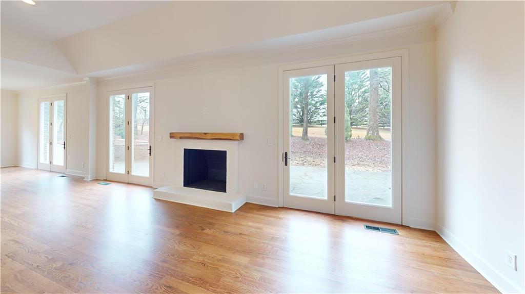 66 Highland Drive Jefferson, GA 30549 - Photo 53 of 63 an empty room with wooden floor and windows