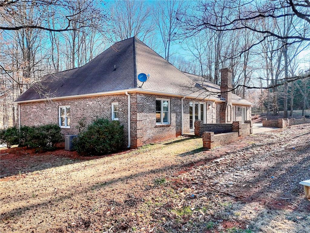 66 Highland Drive Jefferson, GA 30549 - Photo 54 of 63 a view of a house with large trees and a yard