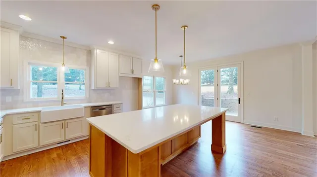 a kitchen with a sink a stove and cabinets