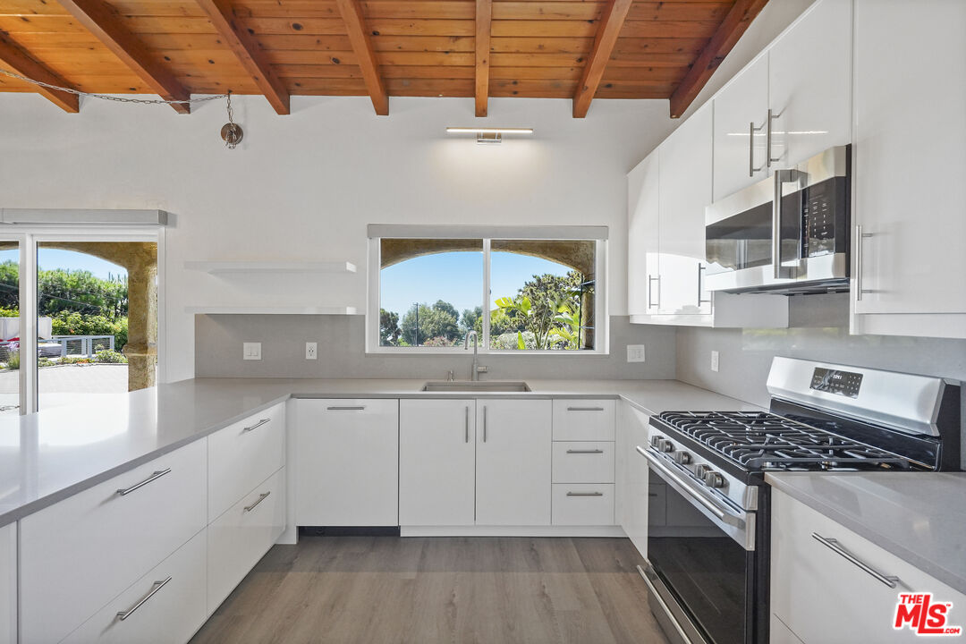 31259 Bailard Road Malibu, CA 90265 - Photo 2 of 43 a kitchen with a sink stove and cabinets