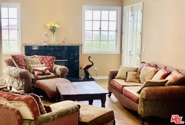 a living room with furniture fireplace and a large window
