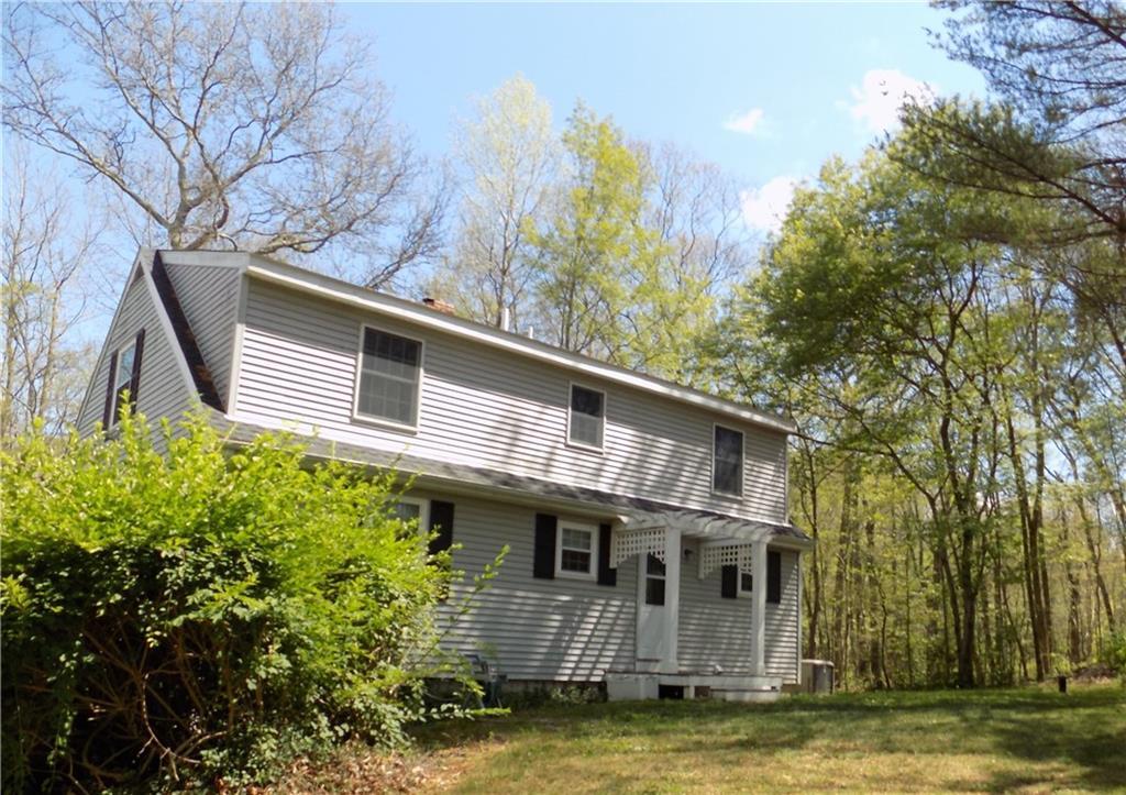 219 Parish Hill Road Chaplin, CT 06235 - Photo 1 of 1 a view of a house with a large window and a tree with yard in front of it