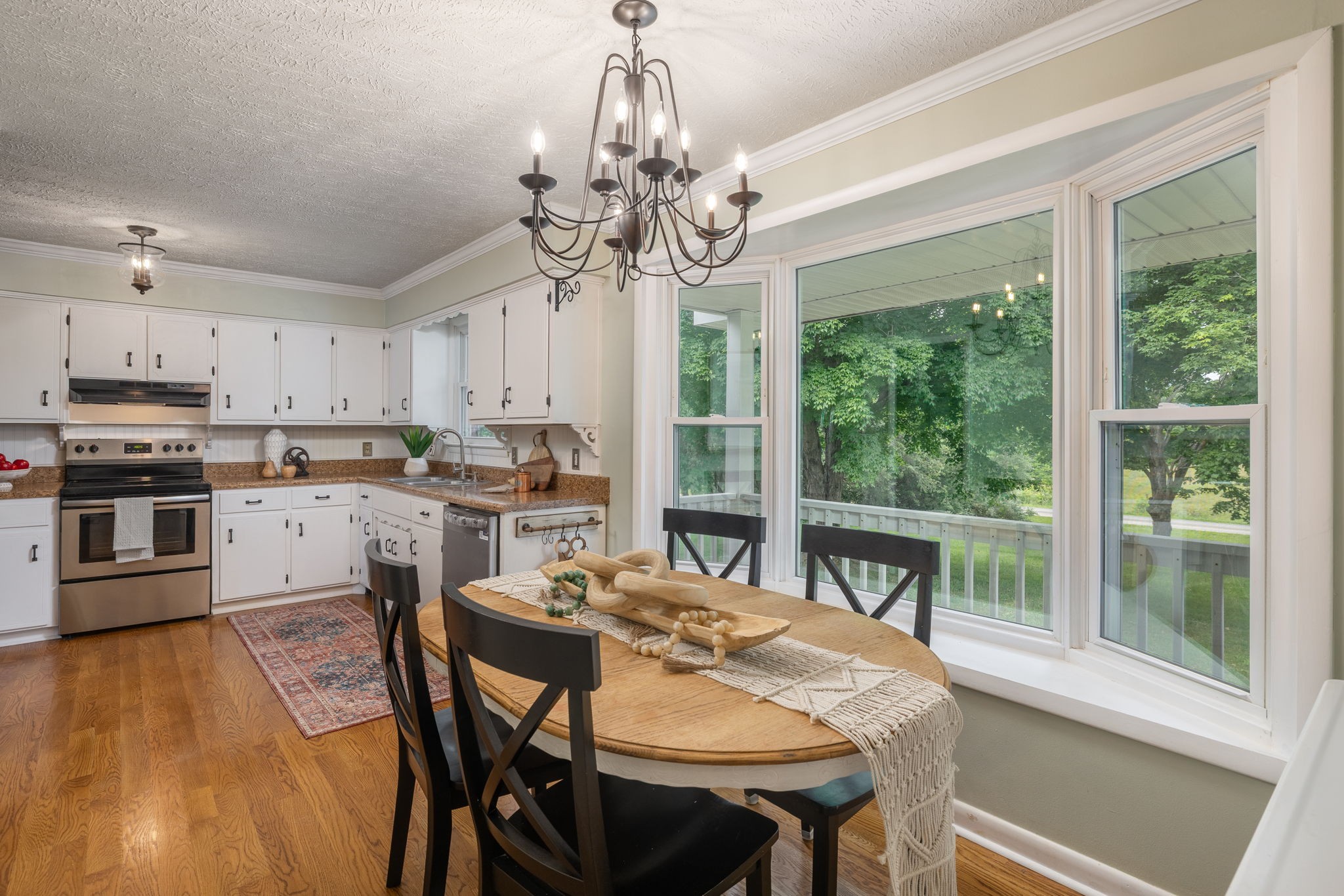 4203 Martins Chapel Road Springfield, TN 37172 - Photo 20 of 52 a kitchen with stainless steel appliances granite countertop a kitchen island hardwood floor sink stove dining table and chairs
