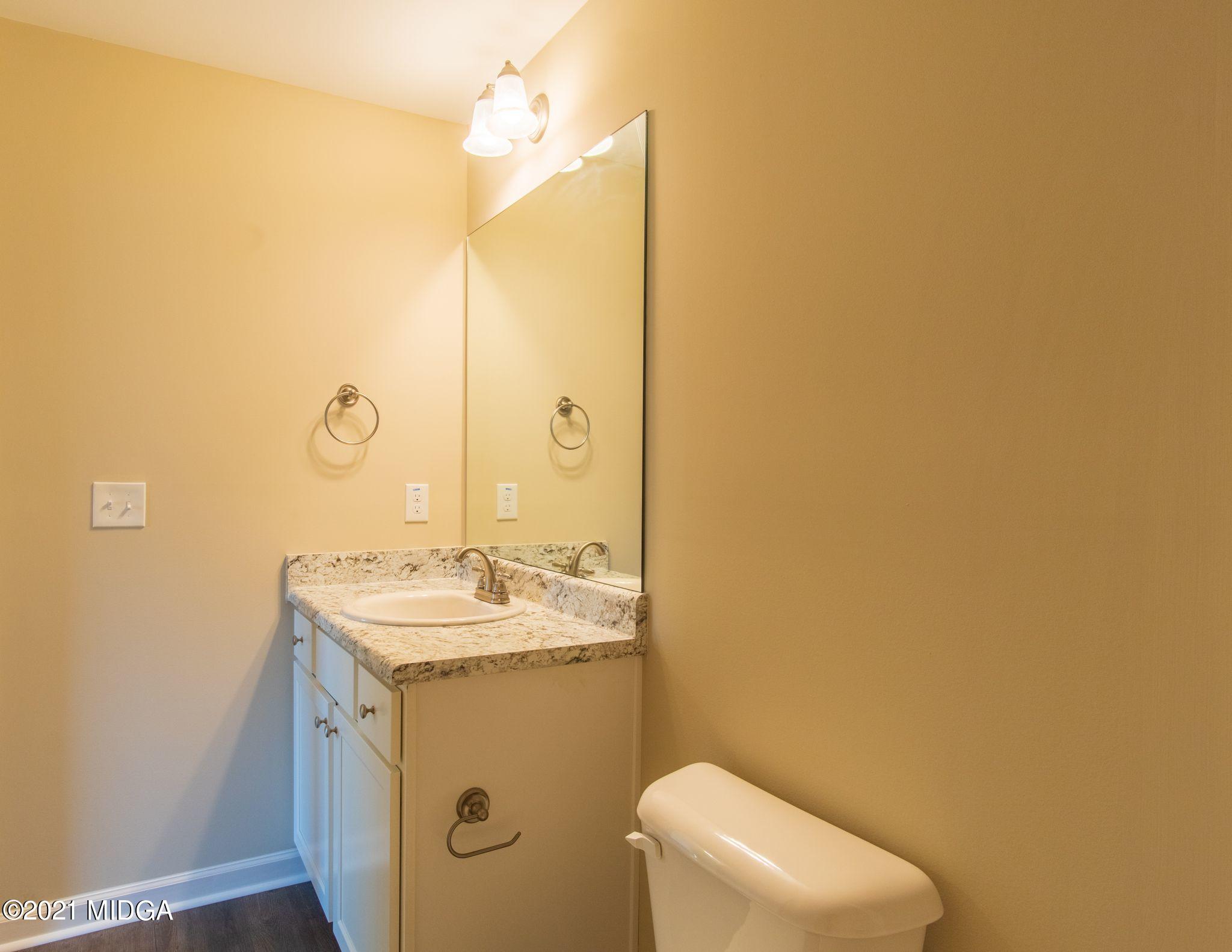 333 Pond View Road Macon, GA 31206 - Photo 12 of 22 a bathroom with a sink a toilet and mirror