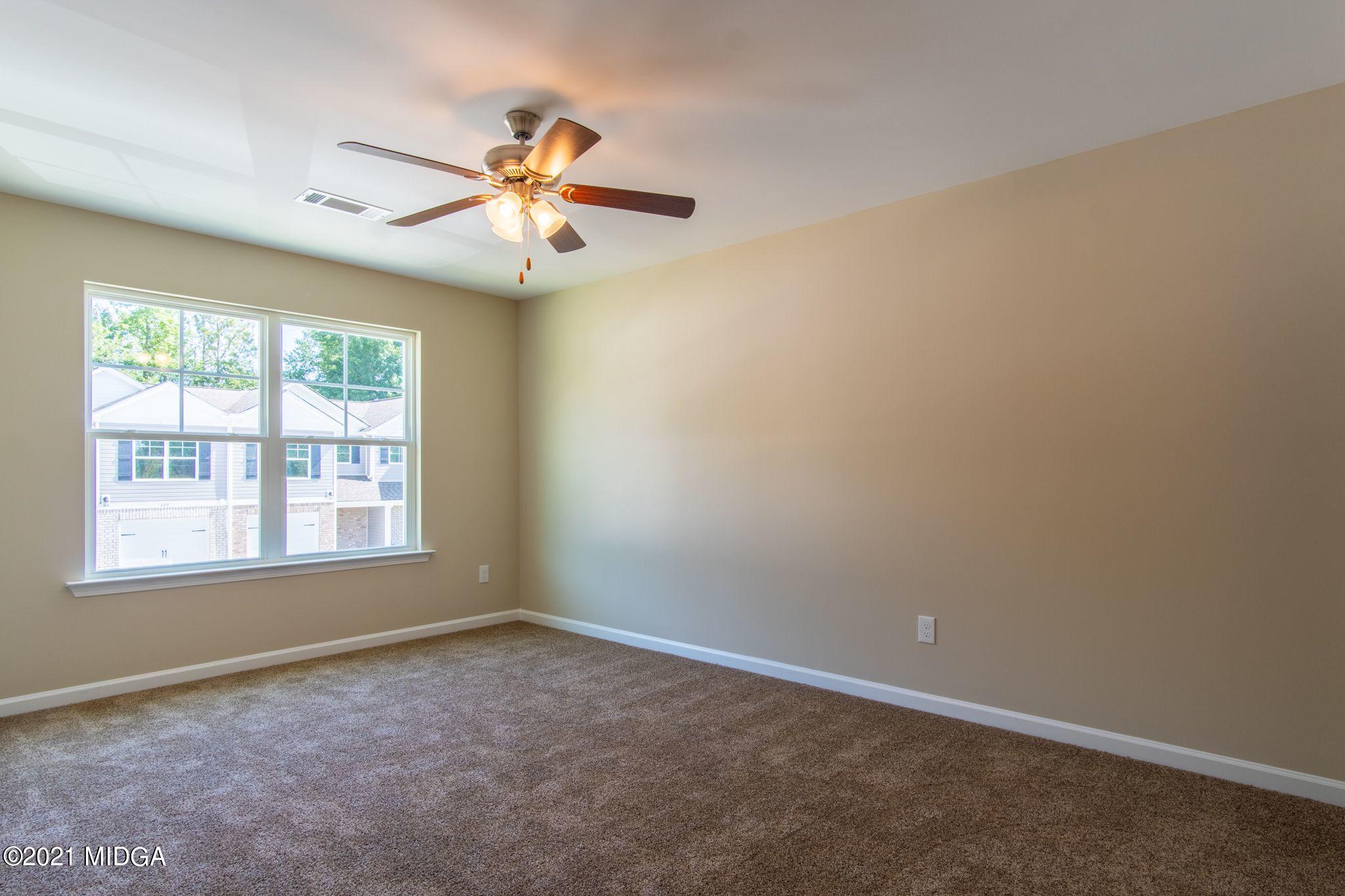 333 Pond View Road Macon, GA 31206 - Photo 13 of 22 an empty room with windows and fan