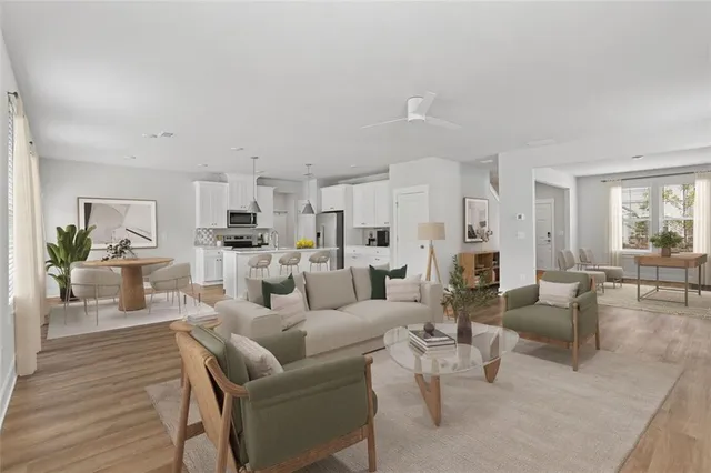 a living room with furniture white walls and wooden floor