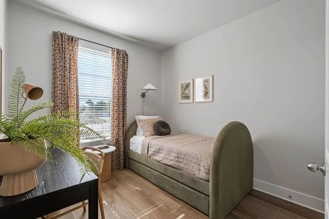 a bedroom with a bed and a potted plant