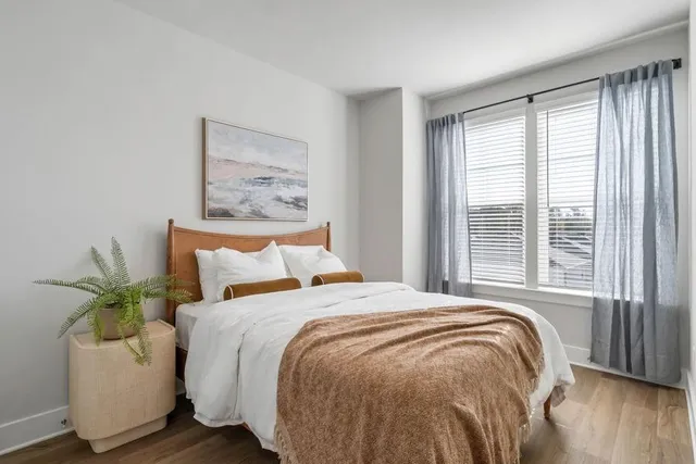 a bed sitting in a bedroom next to a window