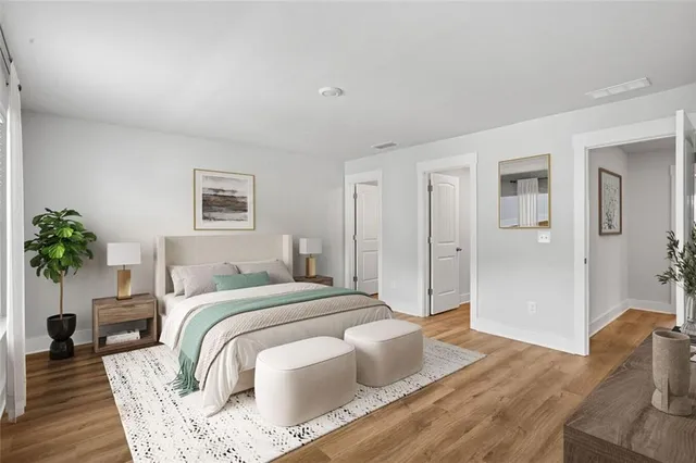 a bedroom with a bed and a potted plant