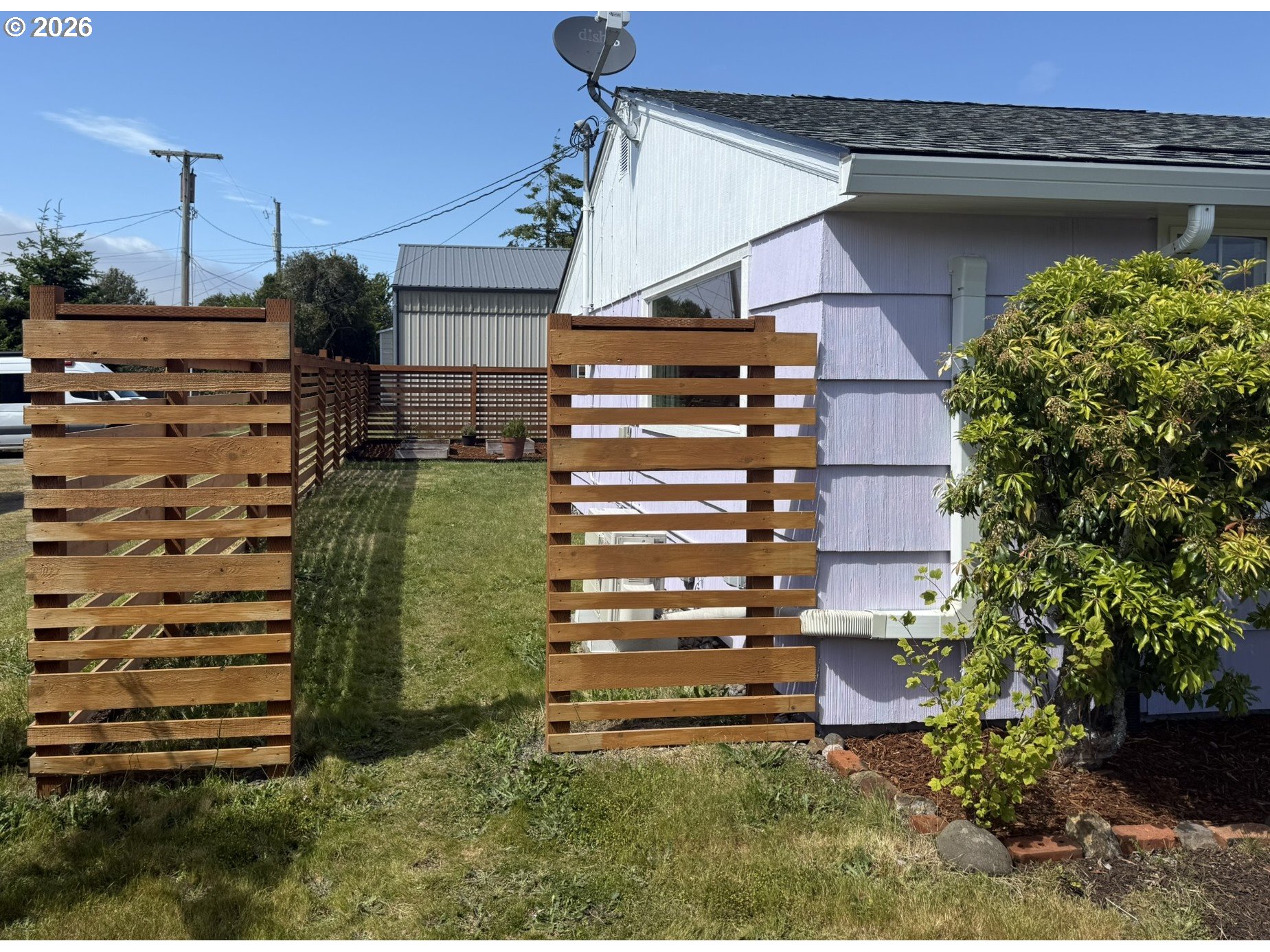 1179 6th Street Florence, OR 97439 - Photo 7 of 26 a view of a house with a garden