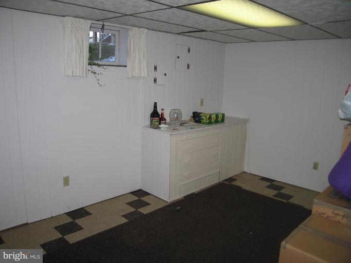 1500 Draper Court Rosedale, MD 21237 - Photo 14 of 14 a storage room with wooden floor and cabinets