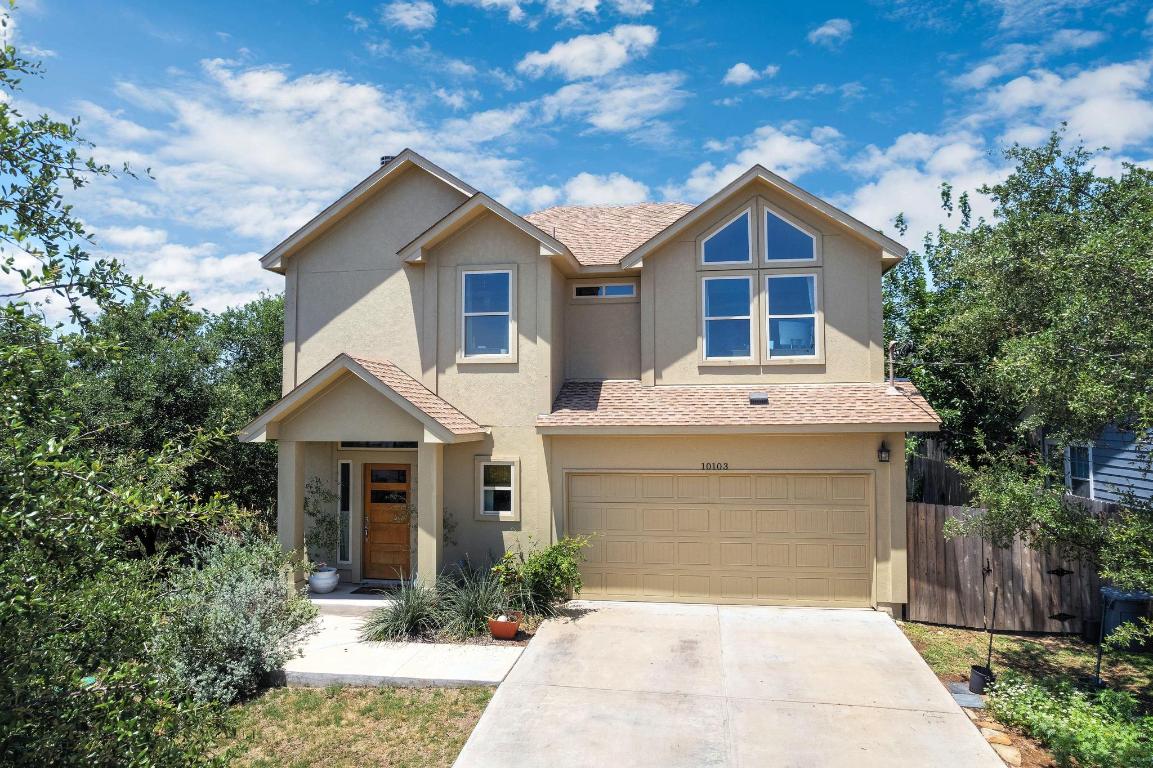 View of front facade featuring stucco siding, an attached garage, roof with shingles, and concrete driveway