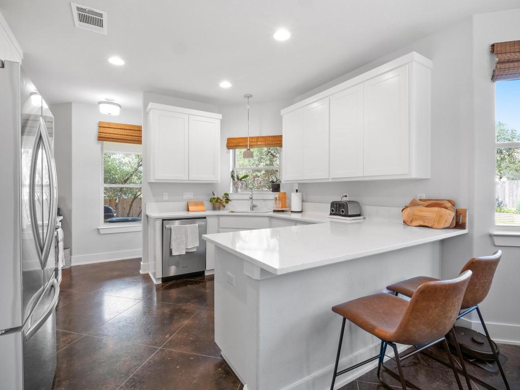 10103 Twin Lake Loop Dripping Springs, TX 78620 - Photo 14 of 32 Kitchen with appliances with stainless steel finishes, a peninsula, a sink, plenty of natural light, and recessed lighting