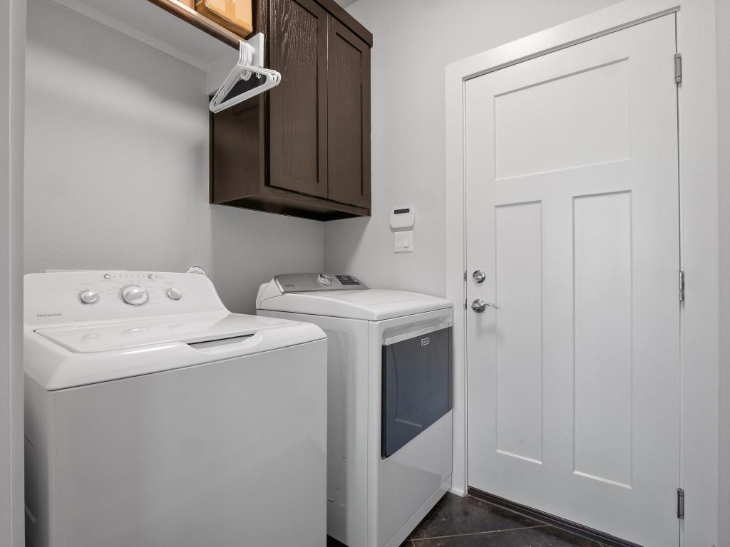 10103 Twin Lake Loop Dripping Springs, TX 78620 - Photo 17 of 32 Laundry room with washer and clothes dryer and cabinet space