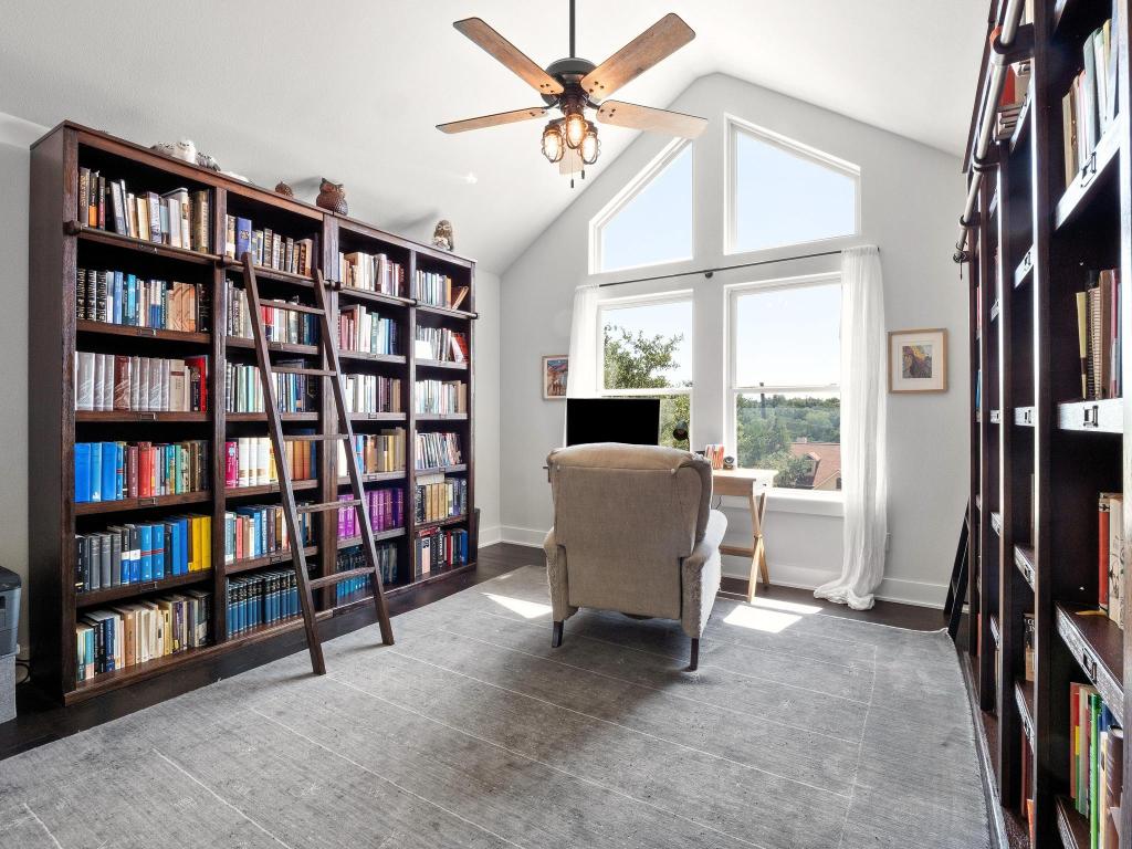10103 Twin Lake Loop Dripping Springs, TX 78620 - Photo 19 of 32 Office space featuring a ceiling fan, plenty of natural light, high vaulted ceiling, baseboards, and bookshelves