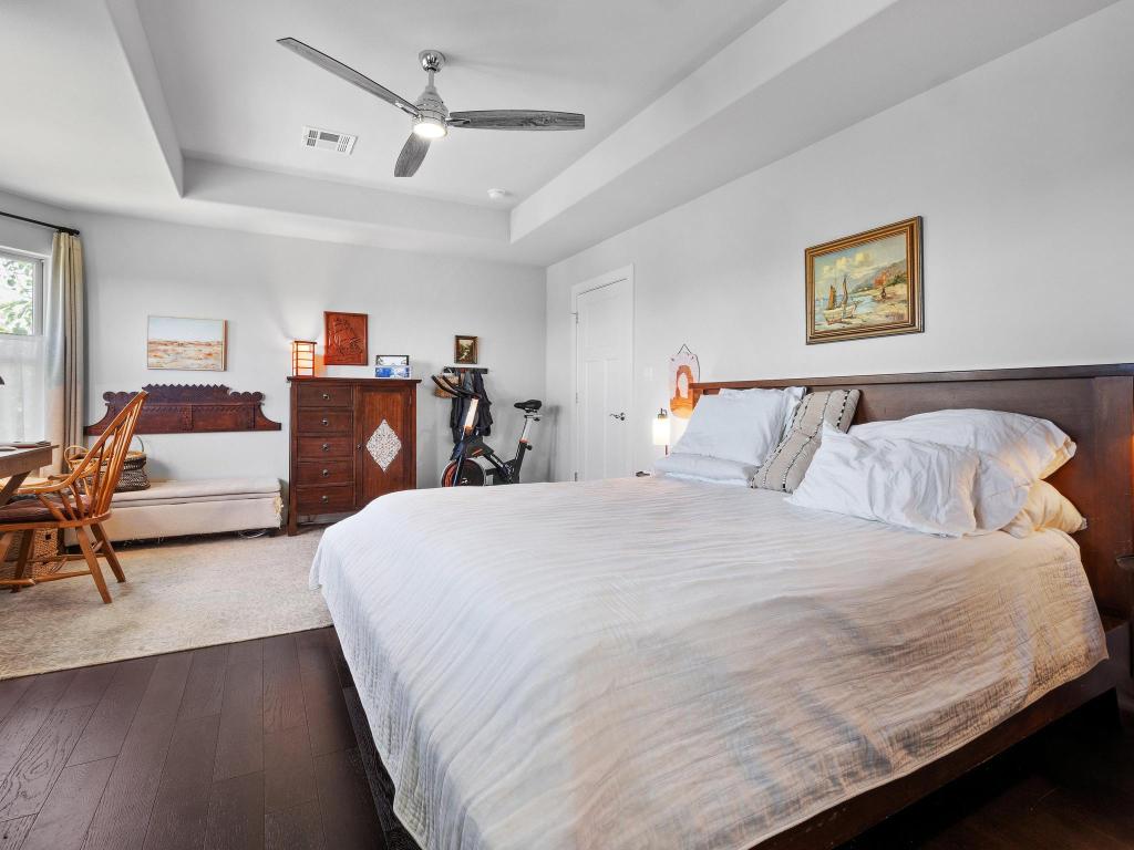10103 Twin Lake Loop Dripping Springs, TX 78620 - Photo 22 of 32 Bedroom with a raised ceiling, dark wood-type flooring, and a ceiling fan