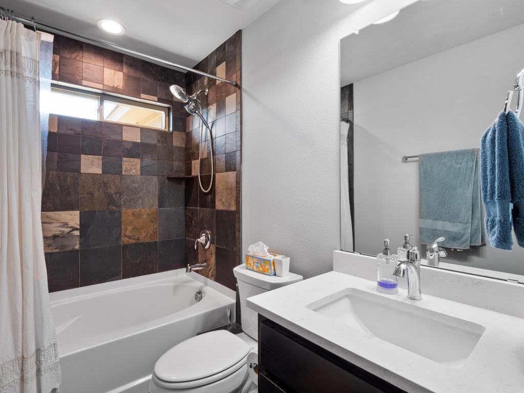 10103 Twin Lake Loop Dripping Springs, TX 78620 - Photo 27 of 32 Bathroom featuring shower / bath combo, vanity, and toilet