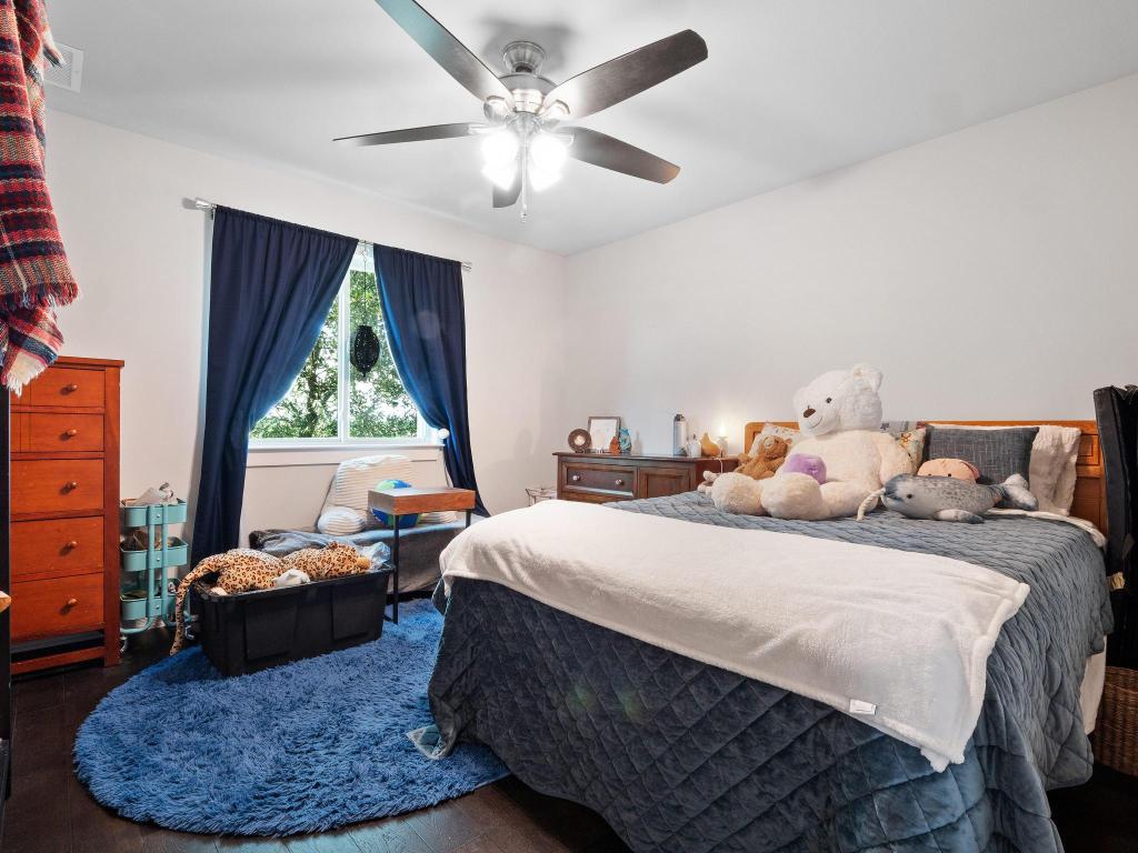 10103 Twin Lake Loop Dripping Springs, TX 78620 - Photo 29 of 32 Bedroom featuring wood finished floors and a ceiling fan