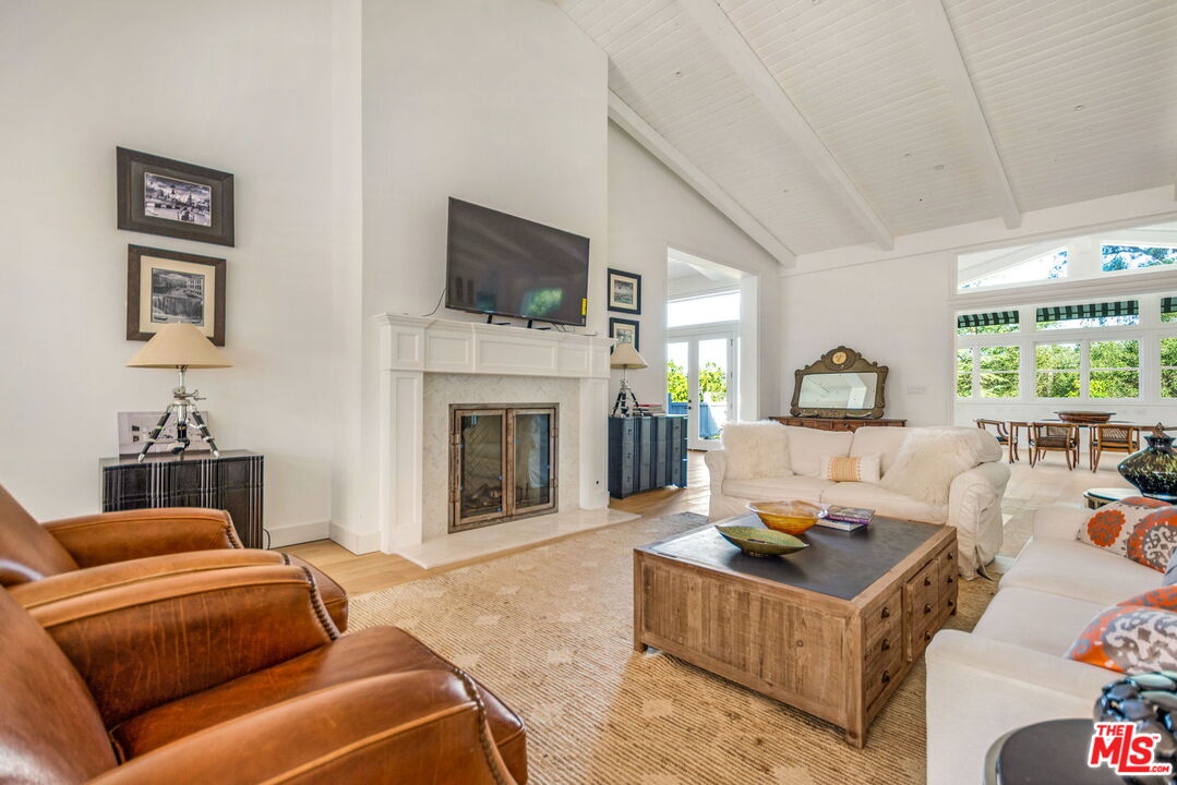 9669 Oak Pass Road Beverly Hills, CA 90210 - Photo 10 of 37 a living room with furniture and a fireplace