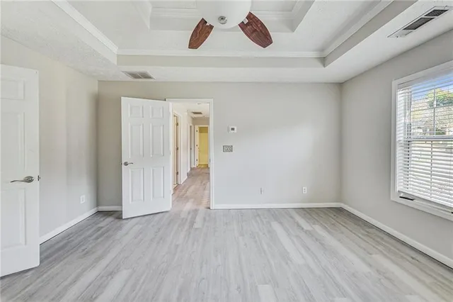 a view of a room with wooden floor and window
