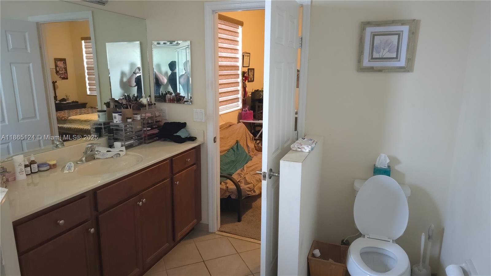 23900 Southwest 117th Court Homestead, FL 33032 - Photo 14 of 24 a bathroom with a toilet sink and mirror