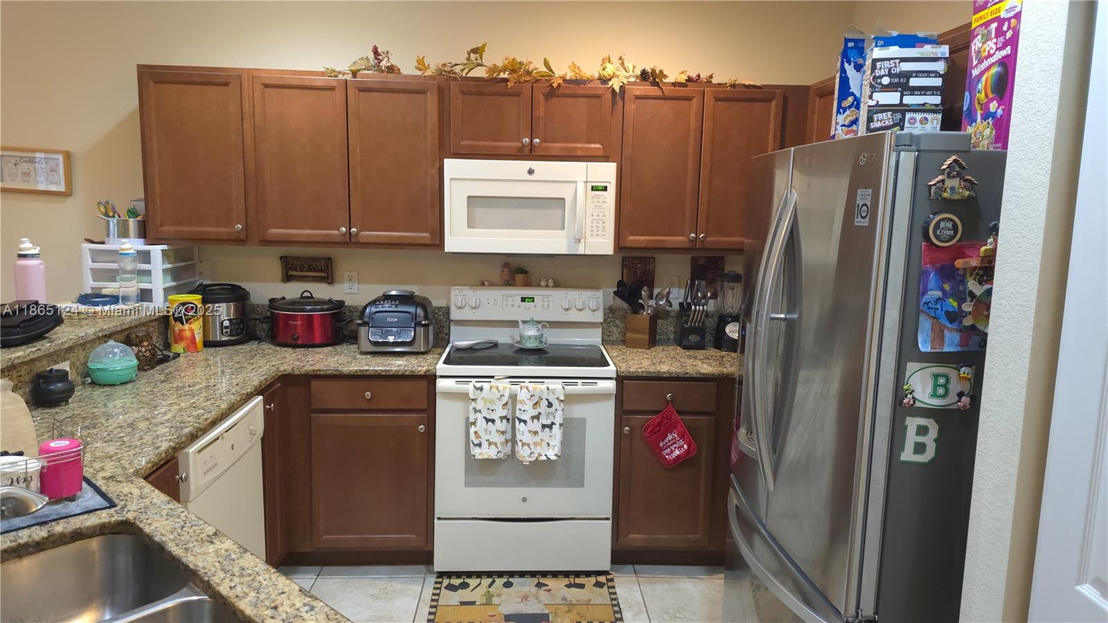 23900 Southwest 117th Court Homestead, FL 33032 - Photo 4 of 24 a kitchen with stainless steel appliances granite countertop a refrigerator and a stove