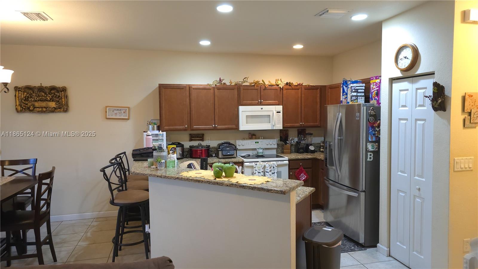 23900 Southwest 117th Court Homestead, FL 33032 - Photo 5 of 24 a kitchen with refrigerator and cabinets