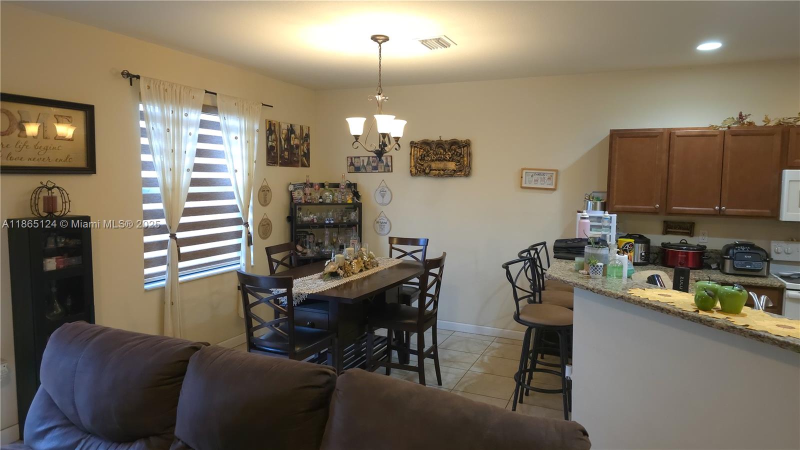 23900 Southwest 117th Court Homestead, FL 33032 - Photo 6 of 24 a room with furniture a chandelier a sink and a window