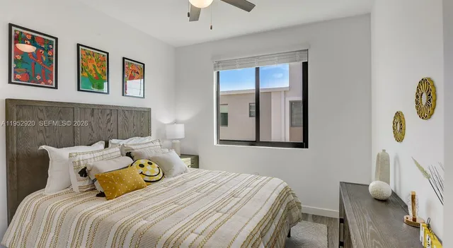 a bedroom with bed and paintings on the wall
