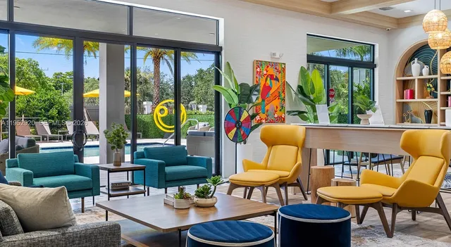 a living room with furniture and a floor to ceiling window