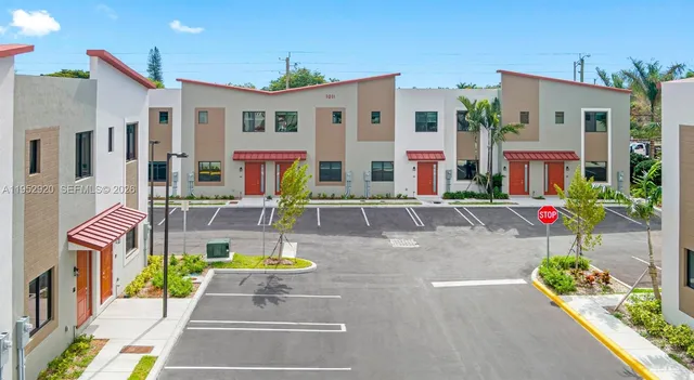 an aerial view of residential houses with yard
