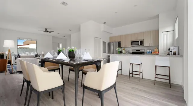 a view of a dining room with furniture and wooden floor