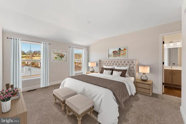 a spacious bedroom with a bed and a couch