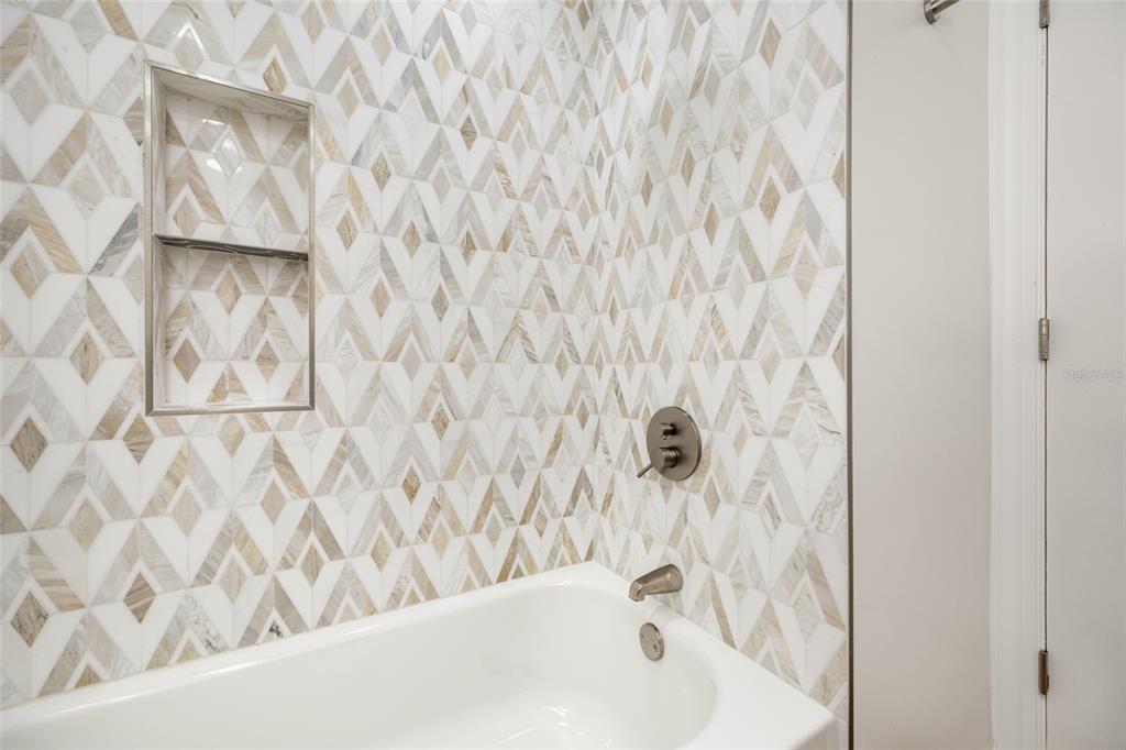 656 Mehlenbacher Road Belleair, FL 33756 - Photo 33 of 49 a bathroom with a bathtub