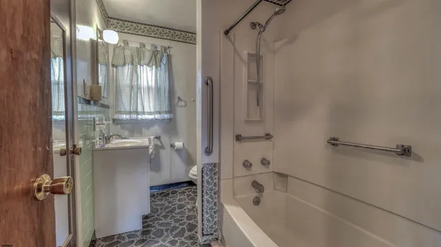 a bathroom with a bathtub and a shower