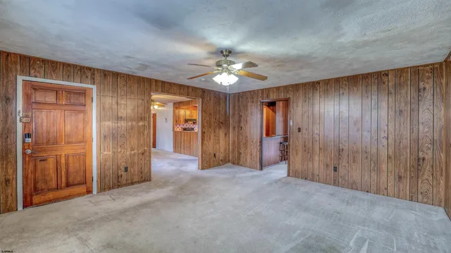 a view of a livingroom with a chandelier fan