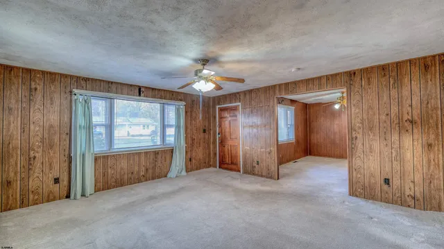 an empty room with windows and closet