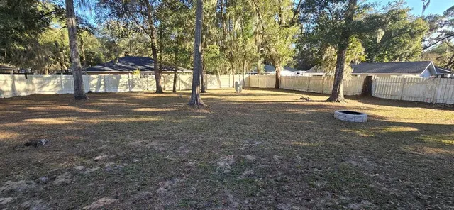a view of a yard with trees