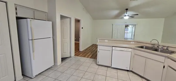 a kitchen with a refrigerator and a sink